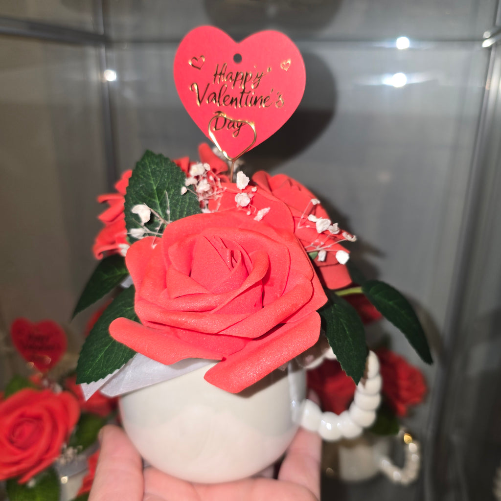 Cups with eternal roses and a message for Valentine's Day