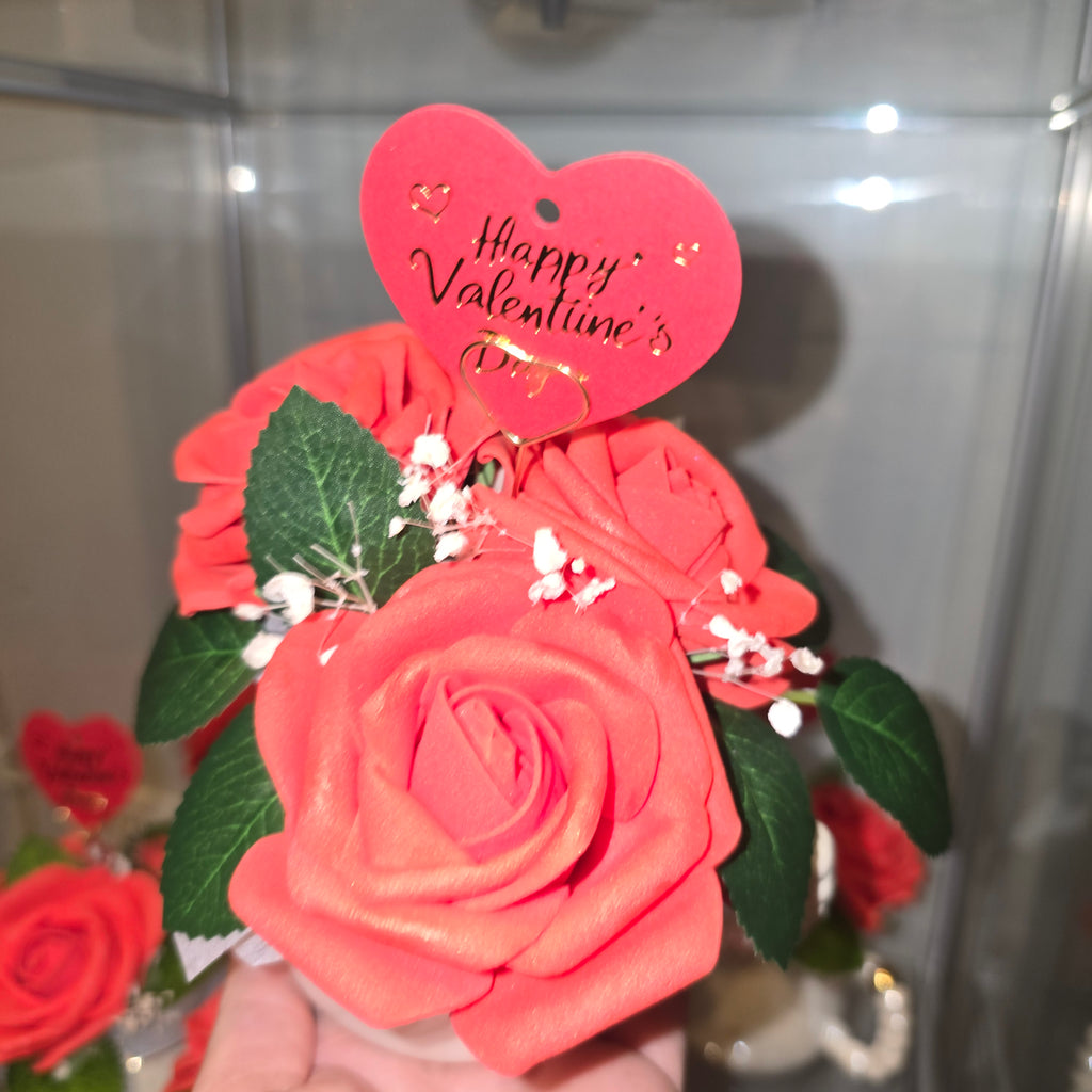 Cups with eternal roses and a message for Valentine's Day