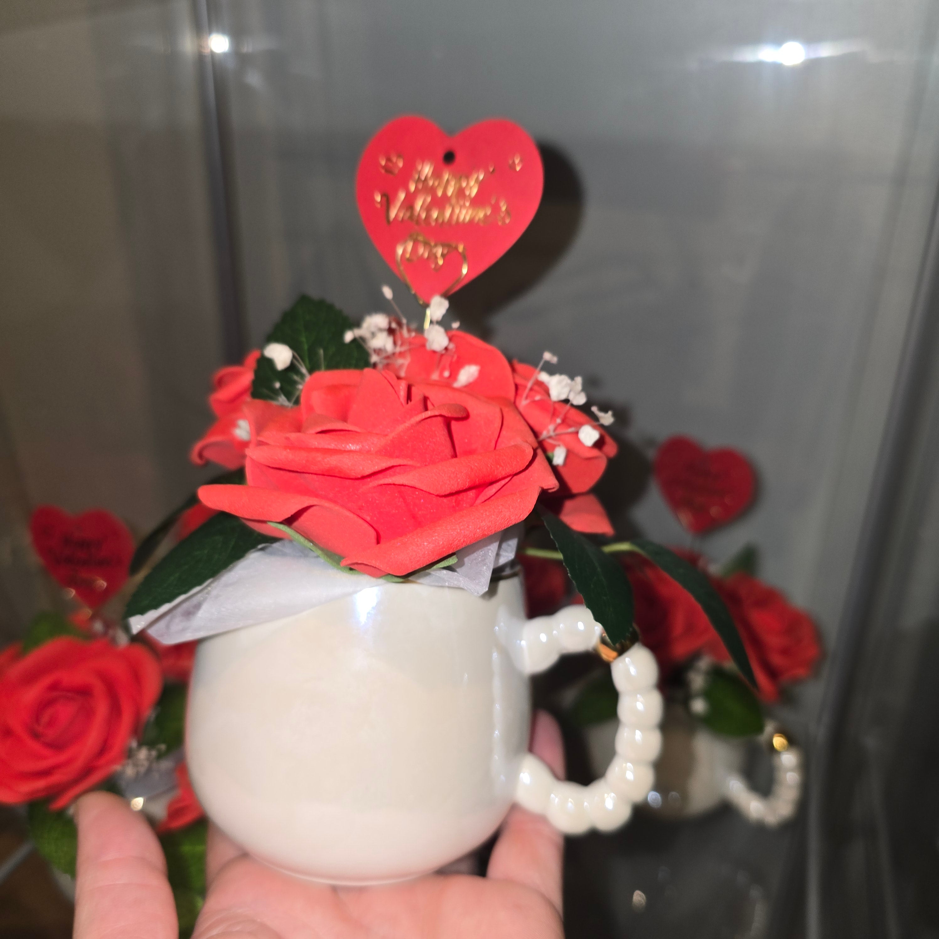 Cups with eternal roses and a message for Valentine's Day