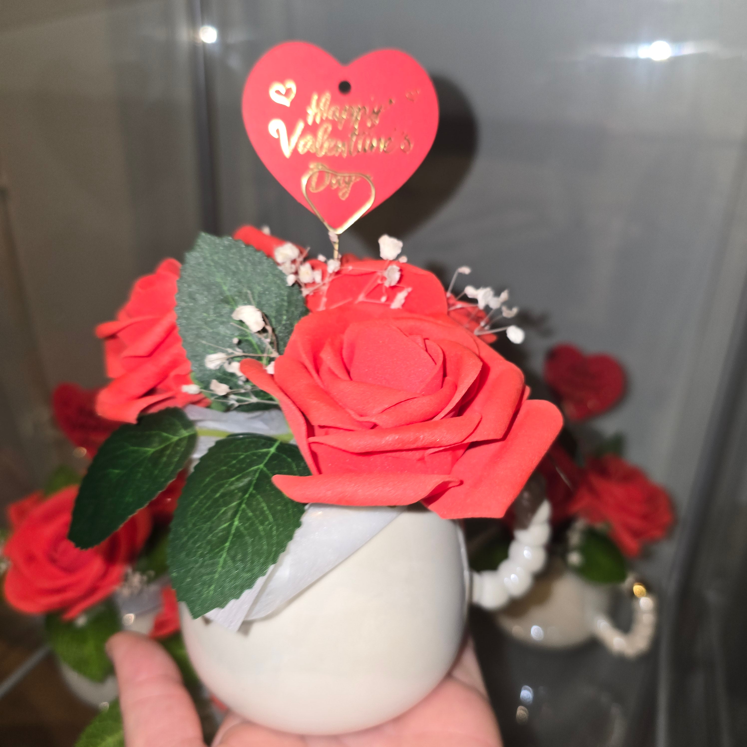 Cups with eternal roses and a message for Valentine's Day