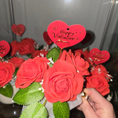 Cups with eternal roses and a message for Valentine's Day
